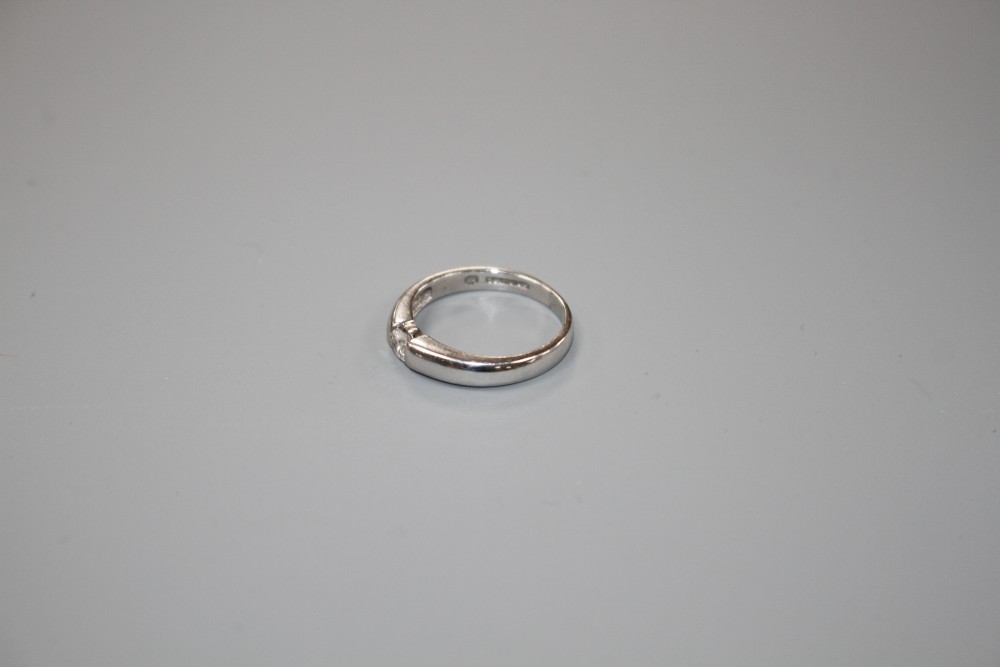 A modern 18ct white gold channel set solitaire diamond ring, size L, gross weight 3.6 grams.